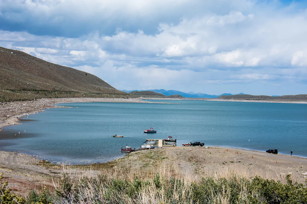 Small fishing boats gathered along the shore of Grant Lake.